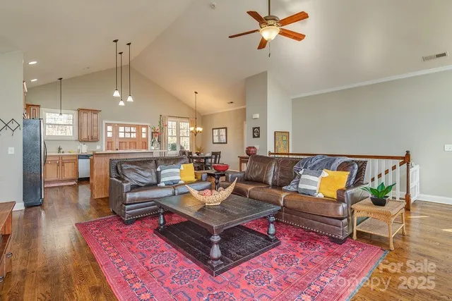 a living room with furniture and kitchen view
