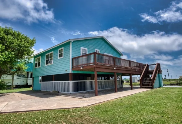 a view of house with yard and seating area