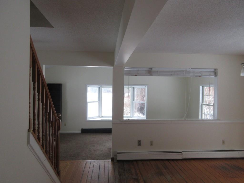 21 Linseed Road Northampton, MA 01060 - Photo 4 of 12 an empty room with wooden floor and windows