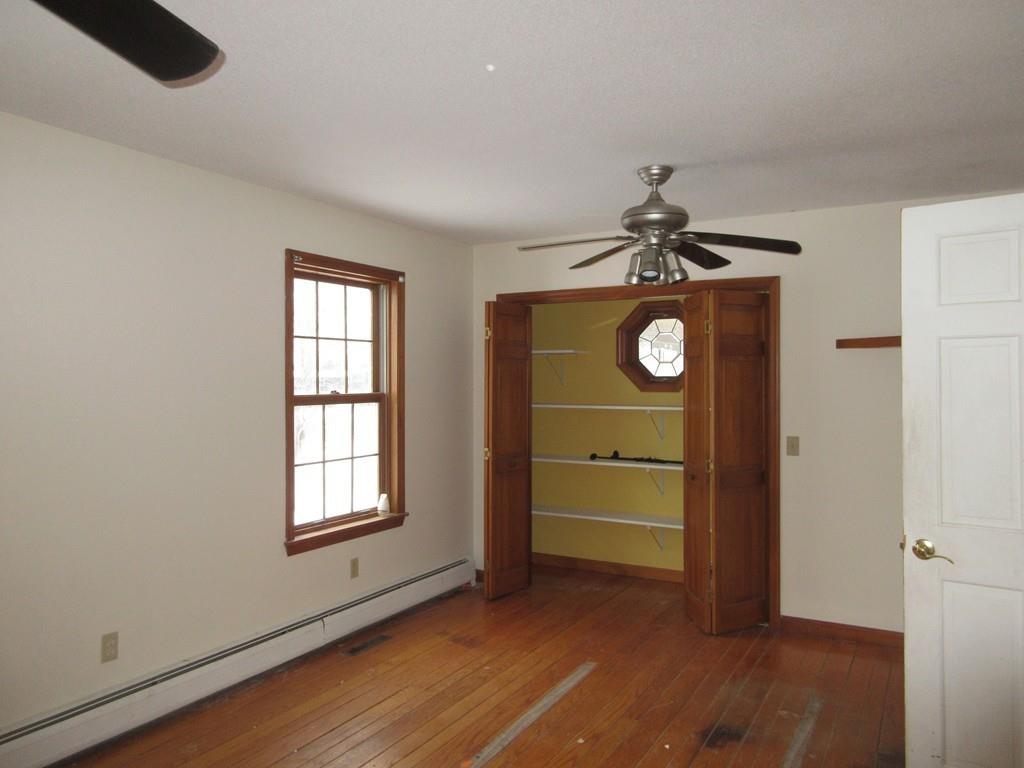 21 Linseed Road Northampton, MA 01060 - Photo 10 of 12 an empty room with wooden floor cabinet and windows