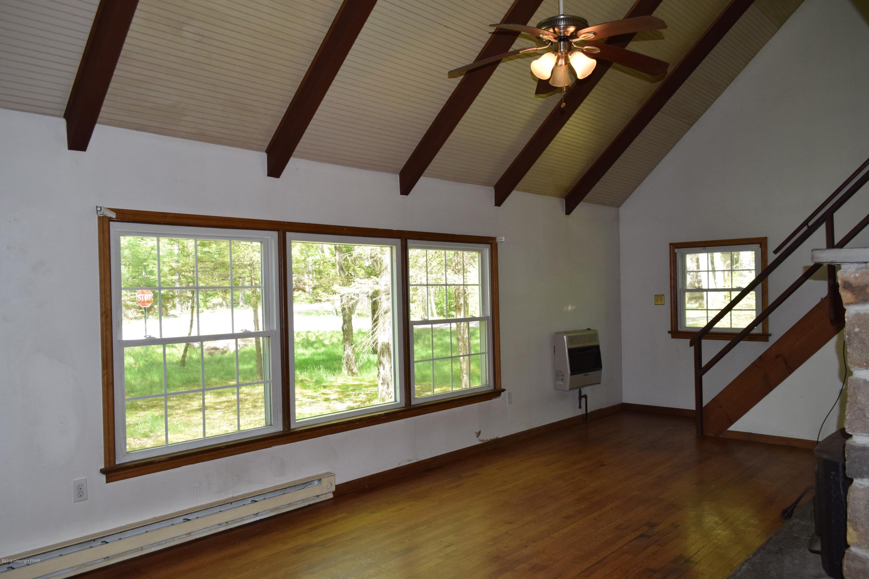 148 Selig Road Pocono Lake, PA 18347 - Photo 4 of 35 a view of empty room with wooden floor and fan