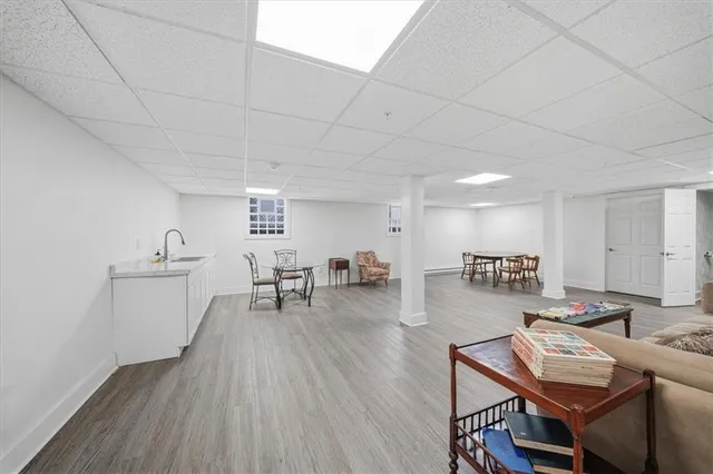 a view of a kitchen with furniture and wooden floor