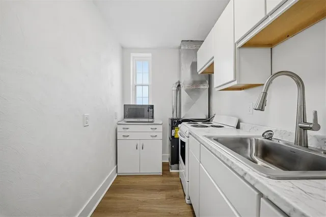 a kitchen with a sink and a stove top oven