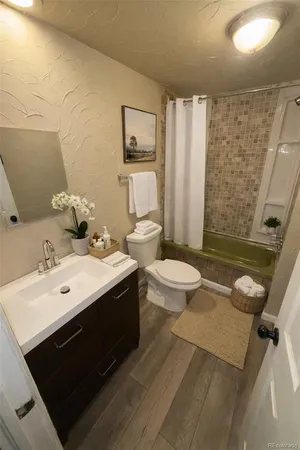 a bathroom with a double vanity sink toilet and shower