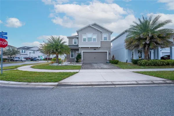 a front view of house with yard and green space