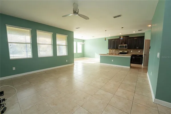 a kitchen with stainless steel appliances granite countertop a sink stove refrigerator and cabinets