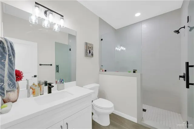 a bathroom with a sink a toilet and shower