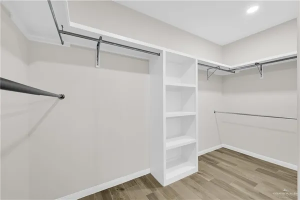 a view of walk in closet with empty racks