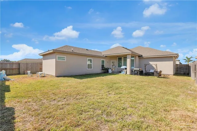 a view of a house with a yard and garage