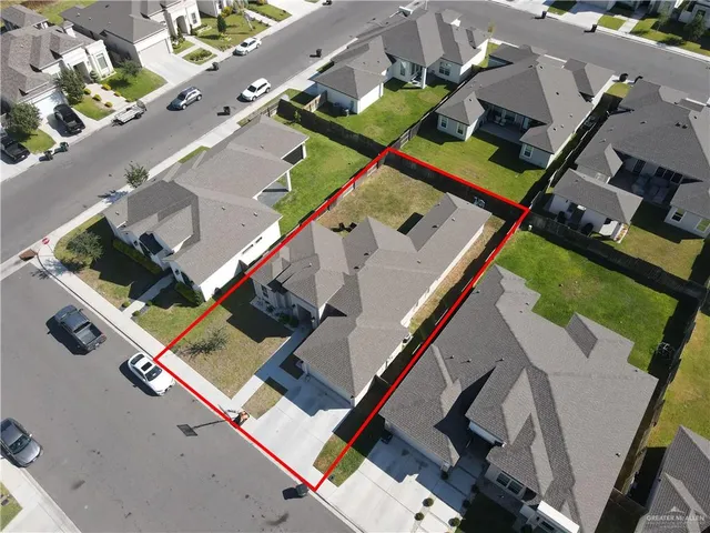 an aerial view of a house with a yard