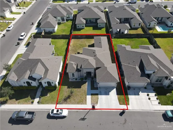 an aerial view of residential houses with outdoor space