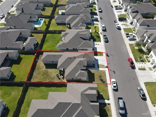 an aerial view of residential houses with outdoor space
