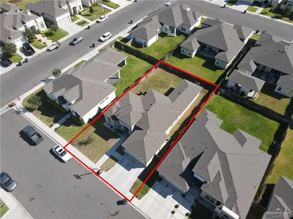 an aerial view of a house with a yard