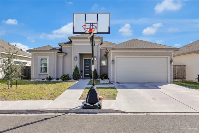 a view of a house with swimming pool and a yard