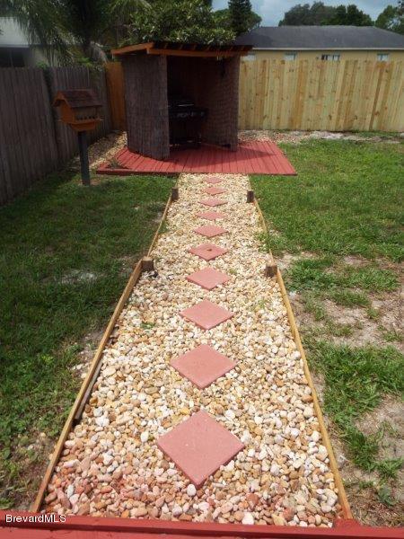 4836 Bridge Road Cocoa, FL 32927 - Photo 8 of 31 pebbled walk way