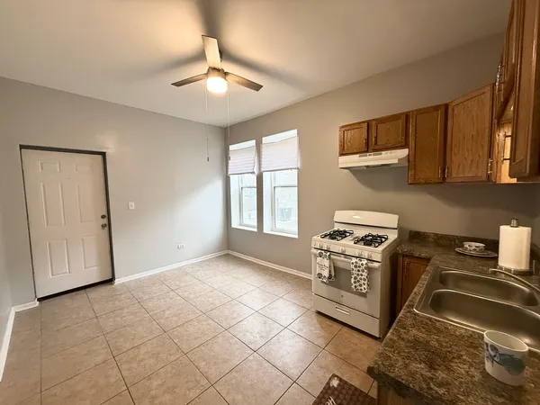 a kitchen with a stove a sink and a refrigerator