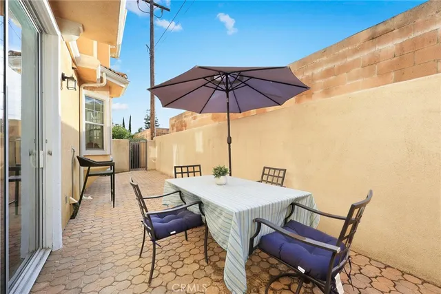 a patio with a table and chairs