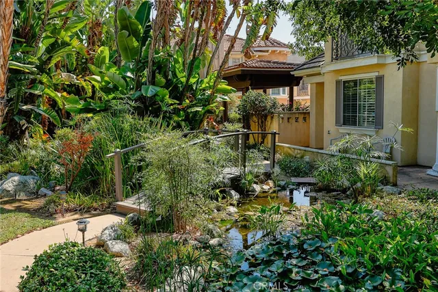 a view of a house with a small yard and plants