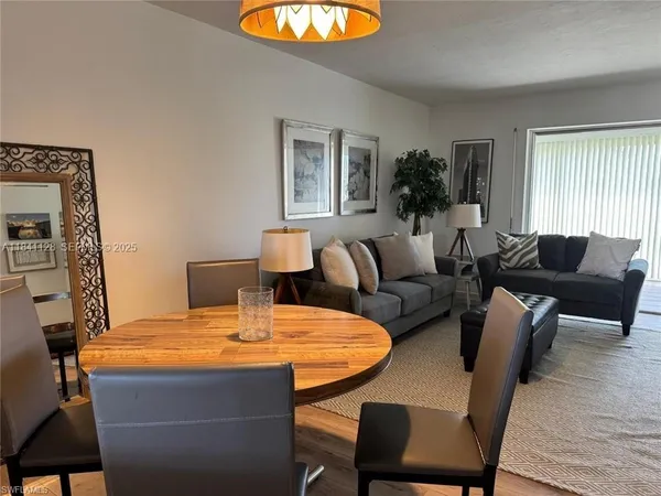 a living room with furniture a table and a large mirror