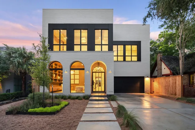 a front view of a house with a garden
