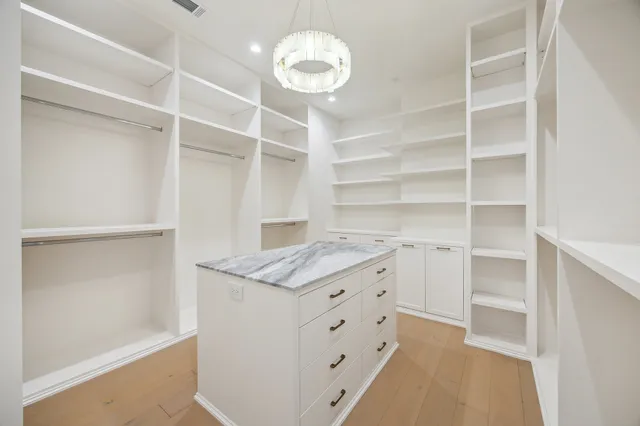 a kitchen with a cabinets and chandelier