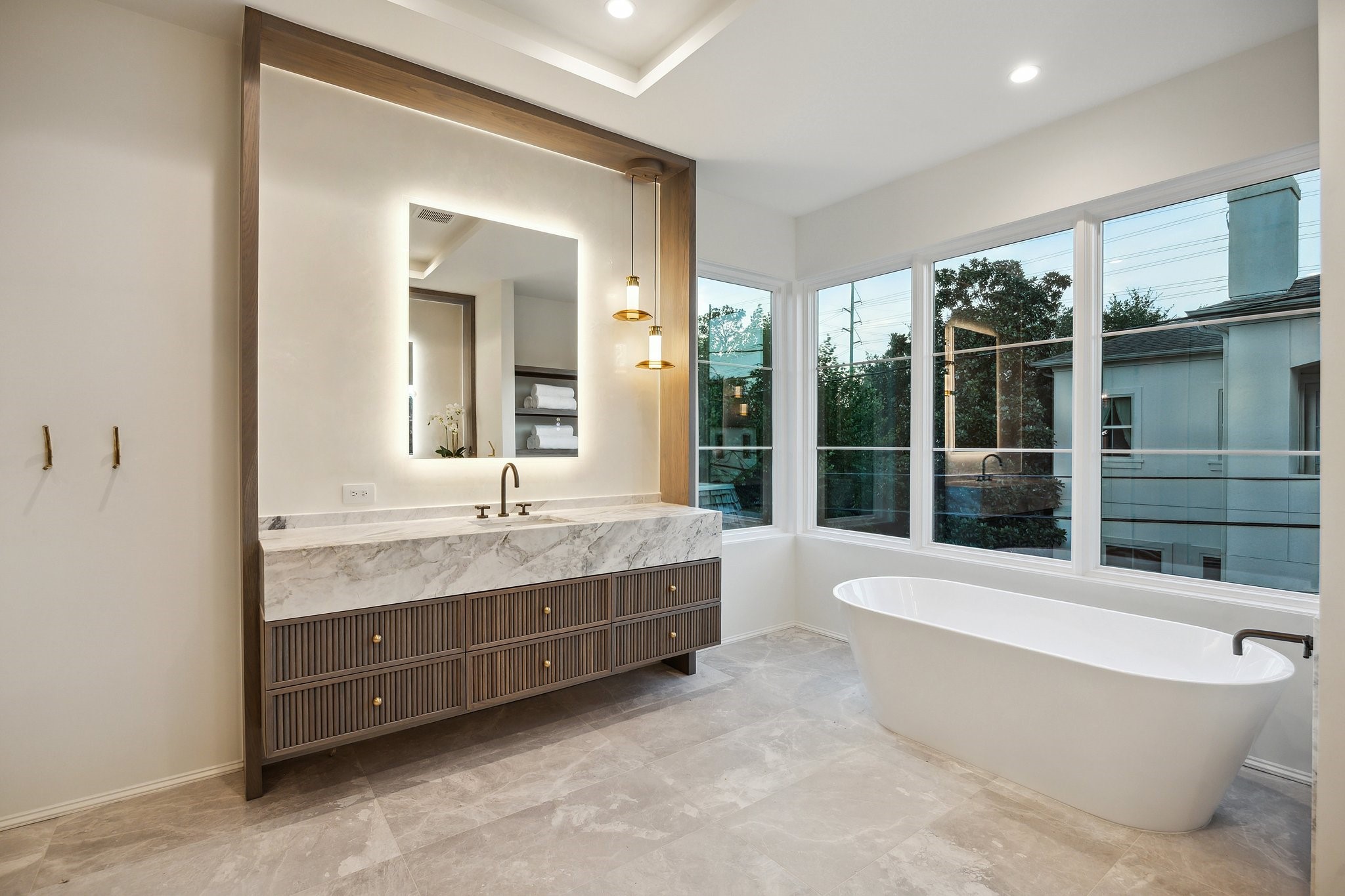 1656 Banks Street Houston, TX 77006 - Photo 27 of 31 a bathroom with a granite countertop tub a sink and a large window