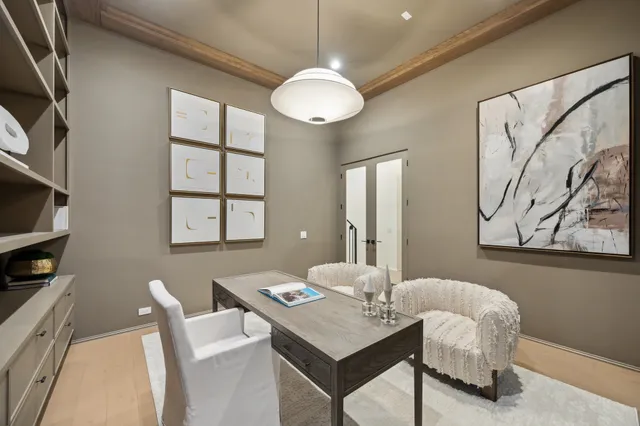 a view of a dining room with furniture and chandelier