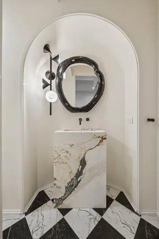 a bathroom with a sink and mirror