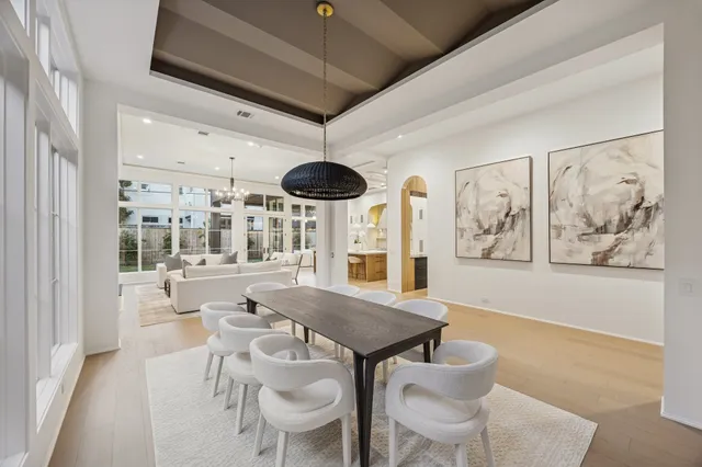 a view of a dining room with furniture wooden floor and chandelier