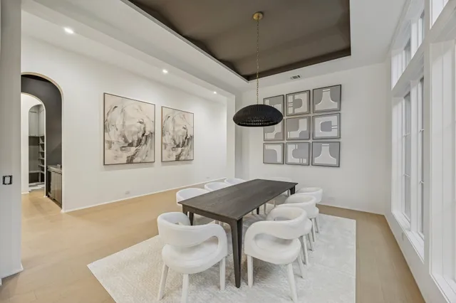 a dinning room with stainless steel appliances kitchen island a table and chairs