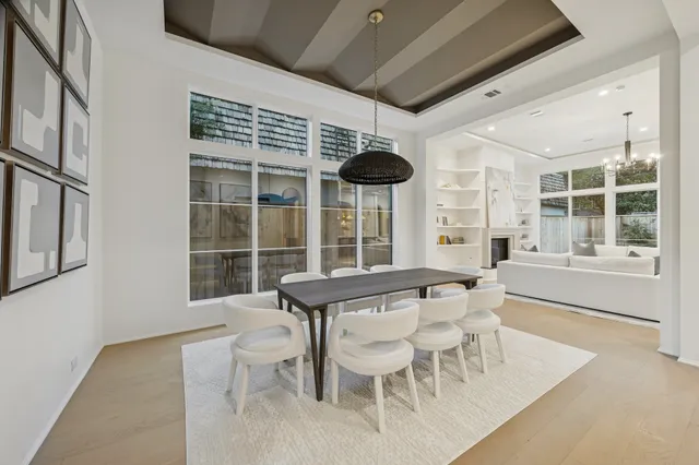 a view of a dining room with furniture large windows and wooden floor