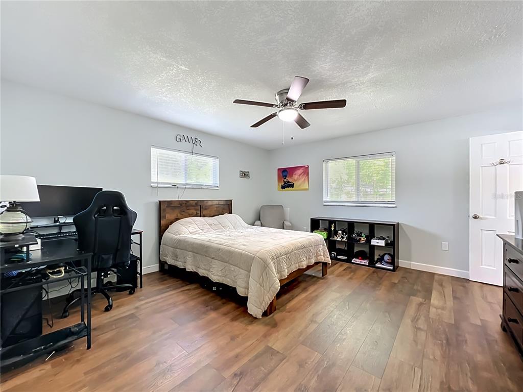 153 Variety Tree Circle Altamonte Springs, FL 32714 - Photo 33 of 44 a bedroom with a bed and a chandelier