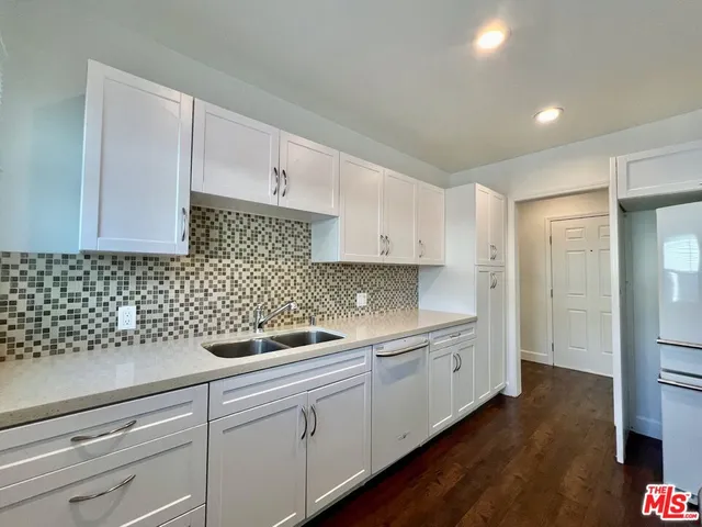 an empty room with wooden floor and closet