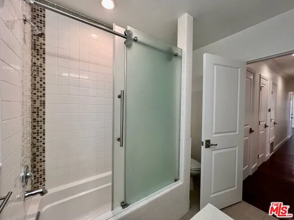 a bathroom with a bathtub and a shower