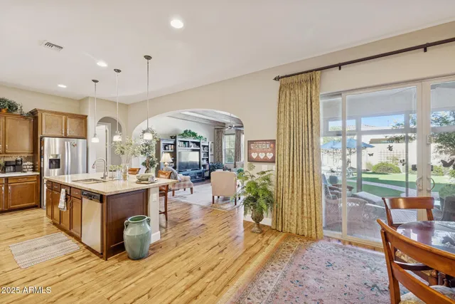 a bedroom with two beds and a chandelier