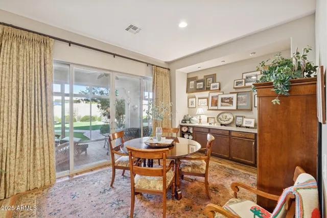 a hallway with mirror on the wall and a potted plant