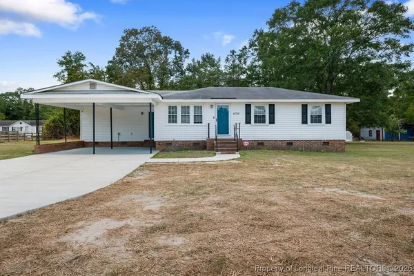 a house with trees in the background