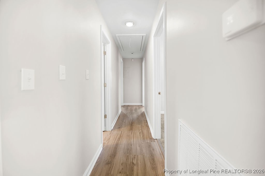 4066 Hummingbird Place Fayetteville, NC 28312 - Photo 13 of 30 a view of a hallway with wooden floor