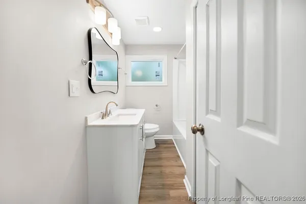 a bathroom with a sink a mirror and a shower