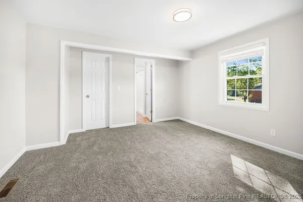 a view of an empty room with a window