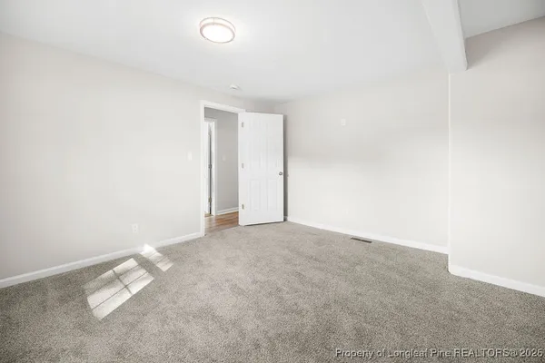 an empty room with a empty space and window