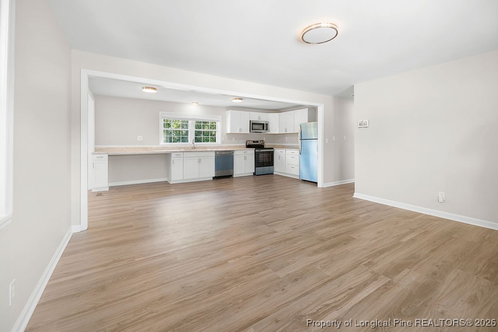 4066 Hummingbird Place Fayetteville, NC 28312 - Photo 8 of 30 a view of cabinets and wooden floor