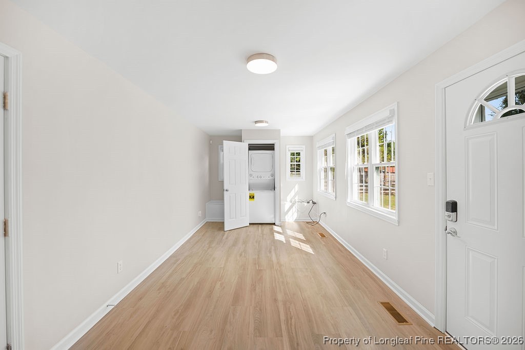 4066 Hummingbird Place Fayetteville, NC 28312 - Photo 10 of 30 a view of an empty room with a window and wooden floor