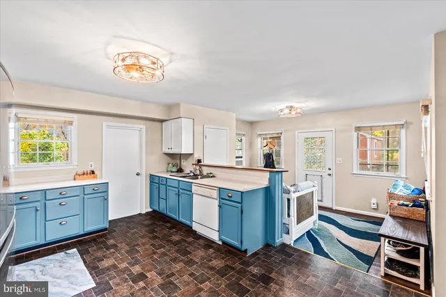 a kitchen with stainless steel appliances a stove a sink and a refrigerator