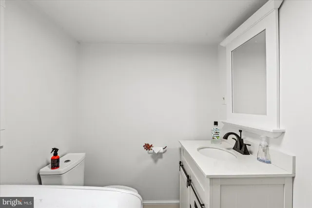 a bedroom with a bed window and dresser