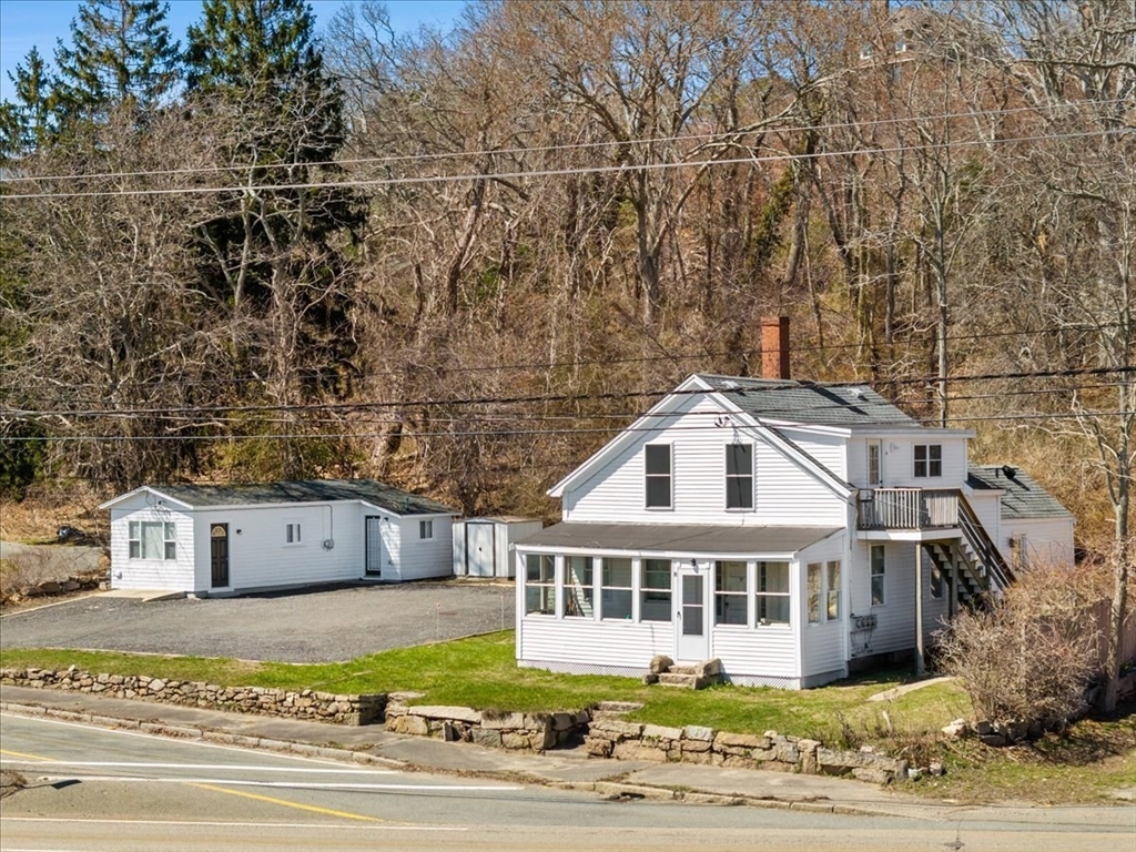 a front view of a house with a garden