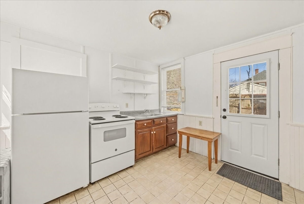 8 Herring Pond Road Bourne, MA 02532 - Photo 11 of 42 a kitchen with a stove a sink and a refrigerator