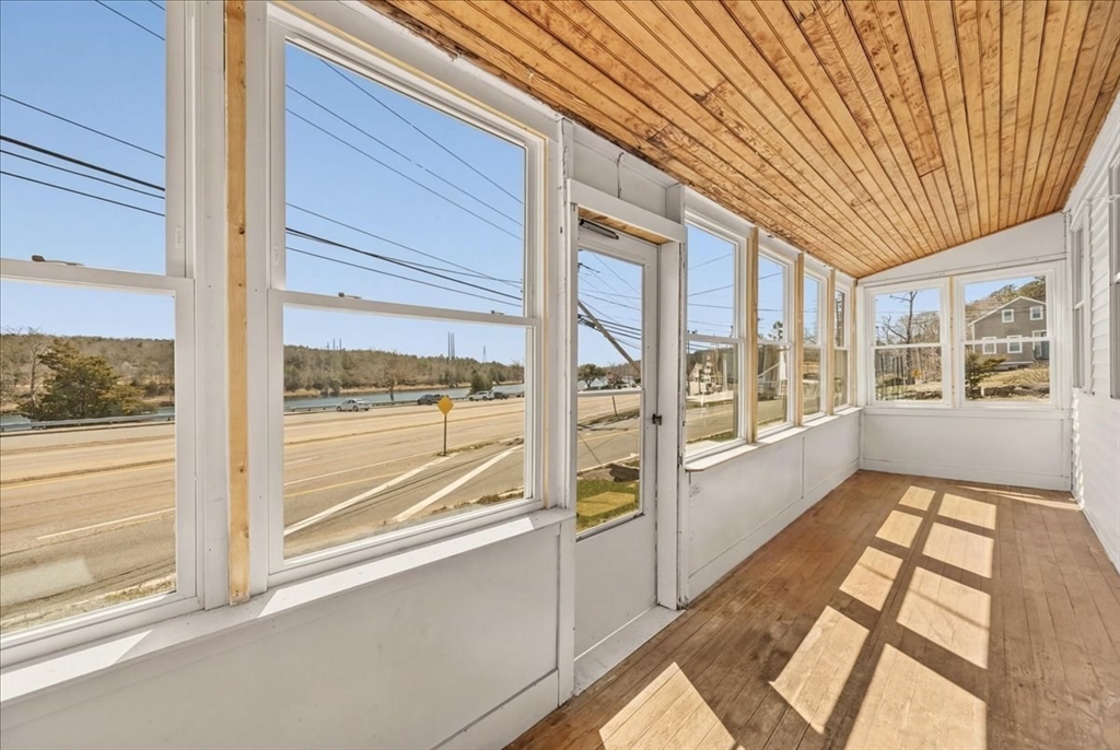 8 Herring Pond Road Bourne, MA 02532 - Photo 16 of 42 a view of a large room with wooden floor and windows
