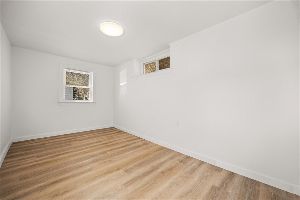8 Herring Pond Road Bourne, MA 02532 - Photo 23 of 42 an empty room with wooden floor and windows