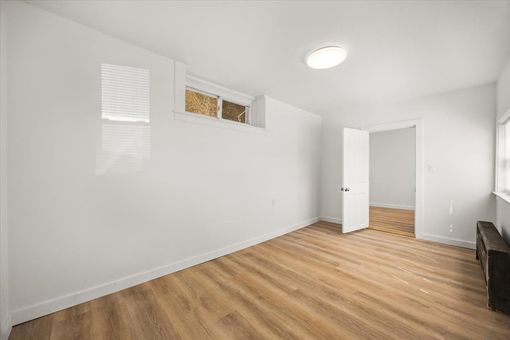 8 Herring Pond Road Bourne, MA 02532 - Photo 24 of 42 a view of an empty room with wooden floor and a window